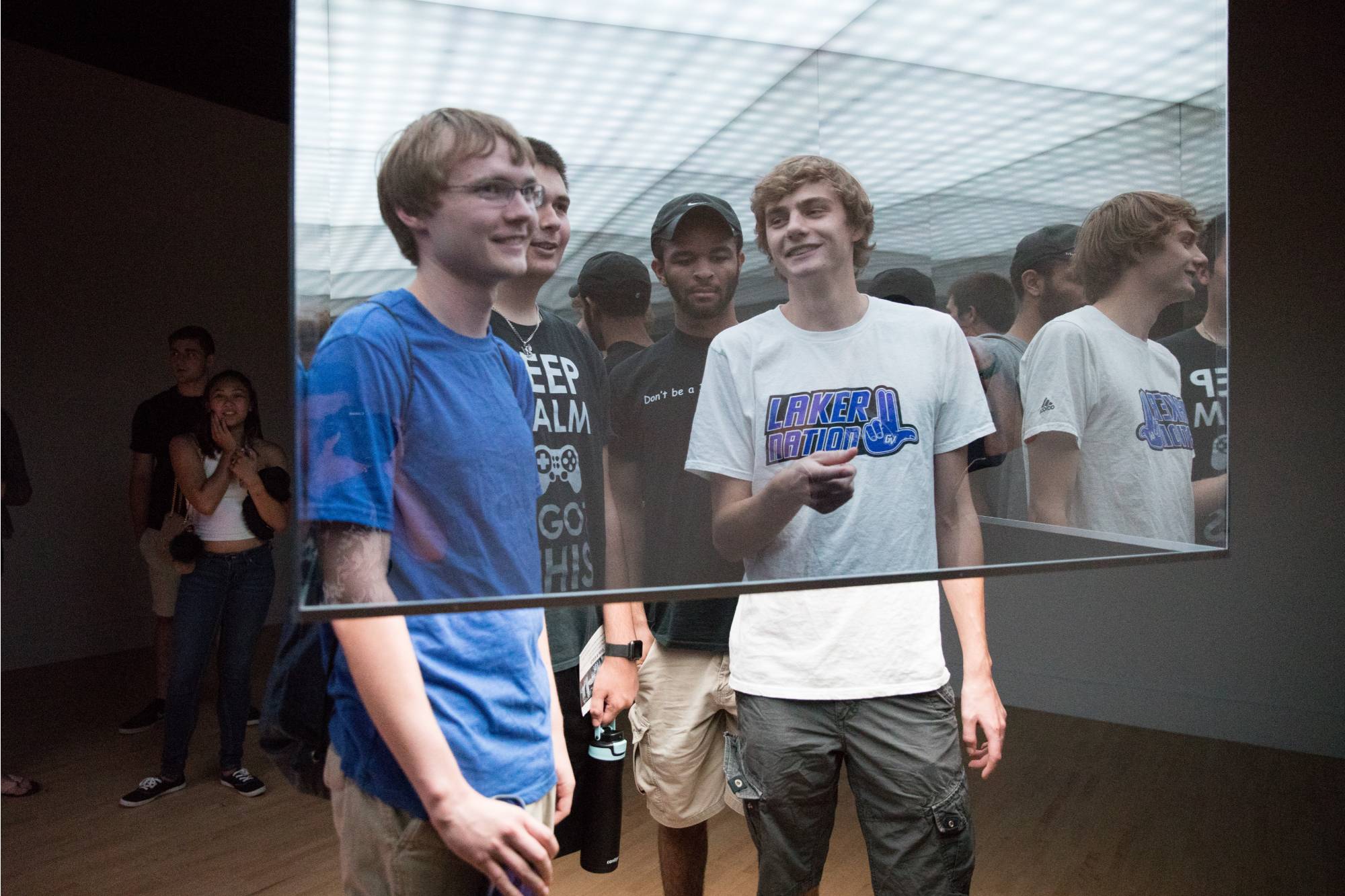 Students within an artwork made of plexiglass